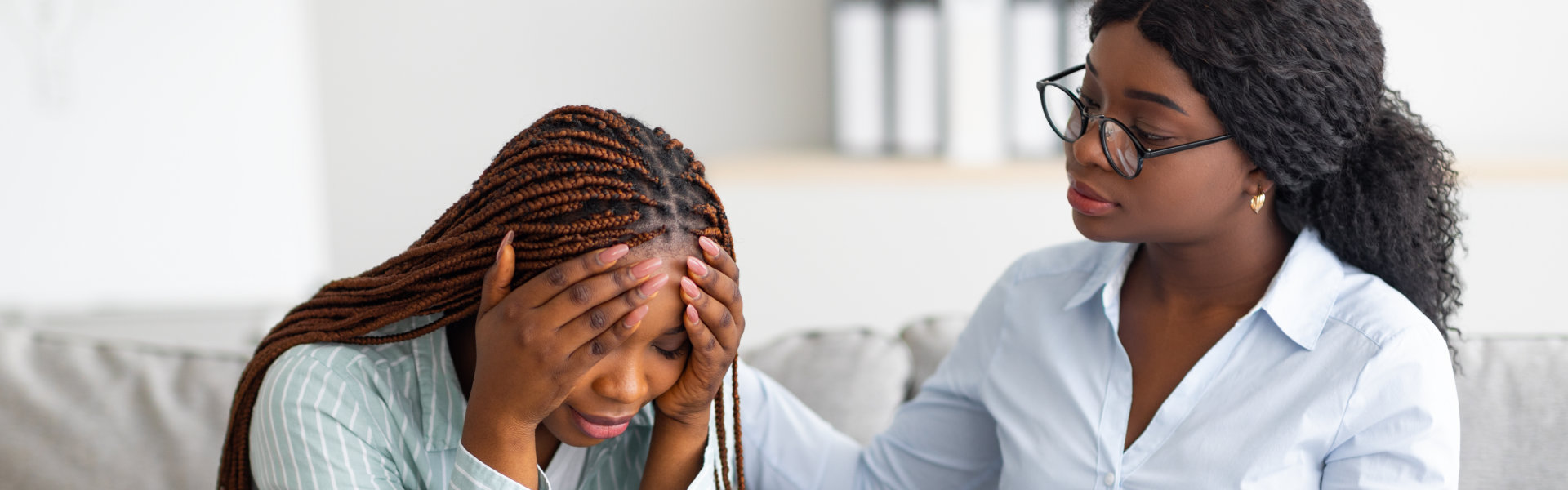 psychotherapist comforting depressed female patient